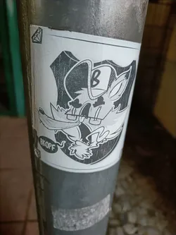 Street sticker A grayscale sticker featuring a cartoon fox wearing a baseball cap with the letter 'B' on it. The fox is depicted in a shield-like shape and has a speech bubble that says 'BKOFF'. The sticker has a slightly worn look.