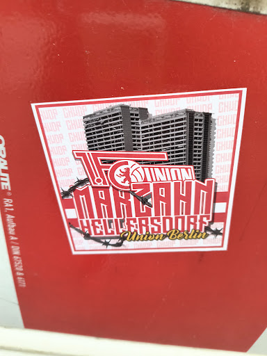 A sticker featuring buildings above the text "FC UNION MARZAHN HELLERSDORF Union Berlin". The text is stylized and has barbed wire around it.