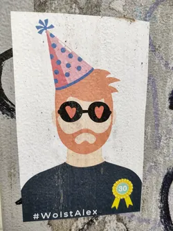 Street sticker A birthday sticker featuring a stylized illustration of a man with a beard wearing heart-shaped sunglasses and a party hat.  The sticker also includes a '30' badge and the hashtag #WolstAlex.