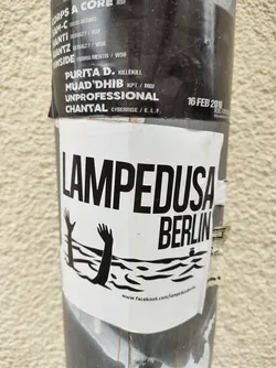 Street sticker Black and white sticker with an illustration of two hands reaching out of the water.  The text 'Lampedusa Berlin' is prominently displayed. A Facebook link is visible at the bottom.