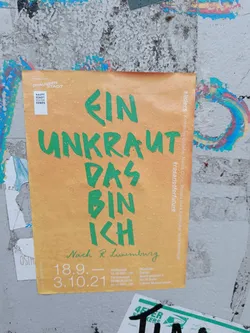 Street sticker A sticker featuring the text "Ein Unkraut das bin ich" (I am a weed) in green lettering on an orange background. It also includes dates (18.9. - 3.10.21), likely referring to an event or exhibition, and mentions  "Nach R. Luxemburg" (Following R. Luxemburg), suggesting a theme related to Rosa Luxemburg's philosophy.  The hashtag #rosariotforfuture is also visible.