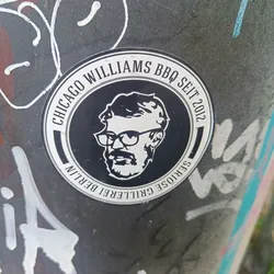Street sticker A round black and white sticker with the text "Chicago Williams BBQ Seit 2012" and "Seriöse Grillerei Berlin" in a circular pattern.  In the center is a black and white illustration of a man with glasses and a beard. 