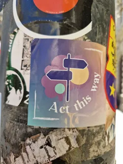 Street sticker A sticker featuring a signpost pointing in a direction with a flower-like design and a pastel color scheme. The text 'Act this way' is prominently displayed.