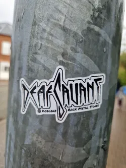 Street sticker A sticker featuring the word "Defiant" in a stylized font, with the text "Rock Metal Stoner" underneath.  The sticker also includes a copyright symbol and "Koblenz".