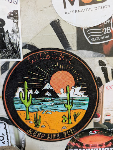 A round Waboba sticker featuring a desert landscape with cacti, mountains, and a setting sun. The text 'WABOBA' is at the top and 'KEEP LIFE FUN' is at the bottom of the sticker.