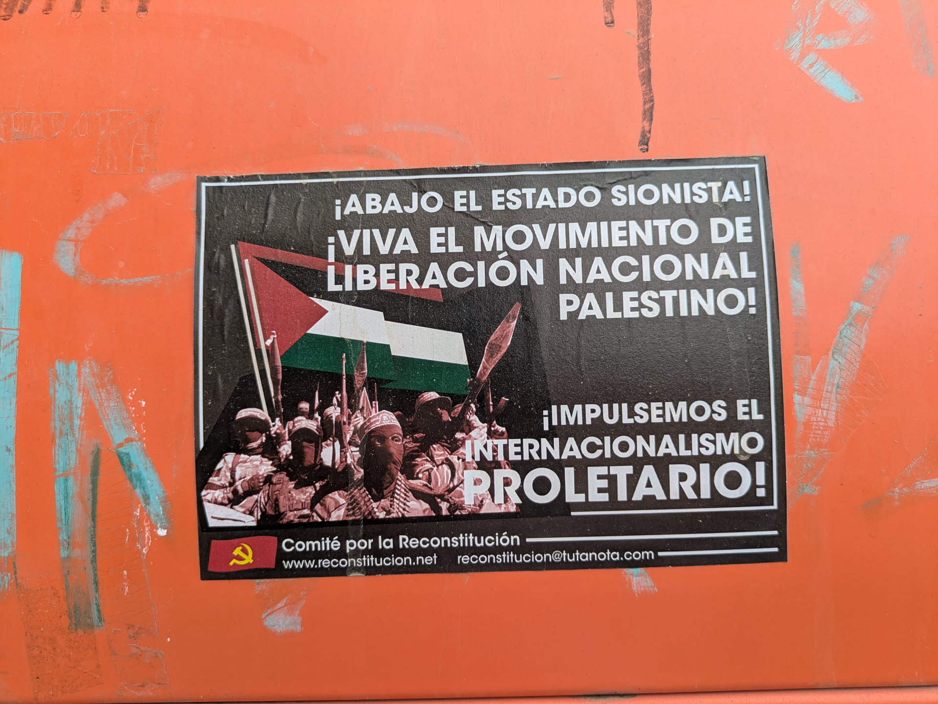 Street sticker The sticker features the Palestinian flag and armed figures, alongside text in Spanish that translates to 'Down with the Zionist state!' and 'Long live the National Liberation Movement of Palestine!' It promotes 'International Proletarianism.' The sticker includes contact information for 'Comité por la Reconstitución' (Committee for the Reconstitution).