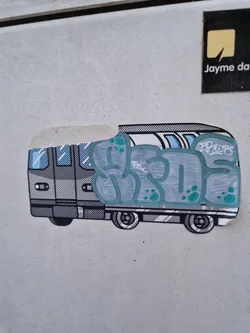 Street sticker A sticker depicting a cartoon-style train with light teal graffiti art on the side. The graffiti is stylized and bubble-like. The sticker is slightly peeled at the top right corner. There are no visible social media handles or QR codes.