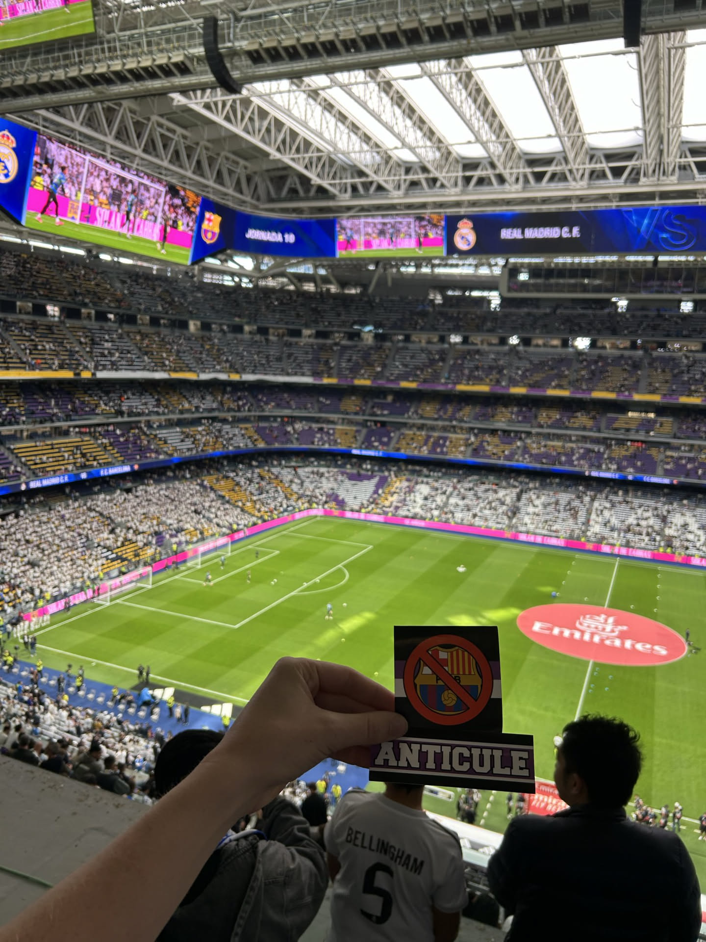 The sticker is rectangular with a black background. The upper part features a red circle with a diagonal line (a 'no' or 'prohibited' symbol) overlaid on the crest of FC Barcelona. The FC Barcelona crest itself is colorful, displaying the red and yellow stripes of the Catalan flag, the St. George's Cross, and a football. Below this design, a dark purple or deep blue horizontal bar contains the word 'ANTICULE' written in prominent white, sans-serif capital letters. The sticker has a clear, glossy finish.