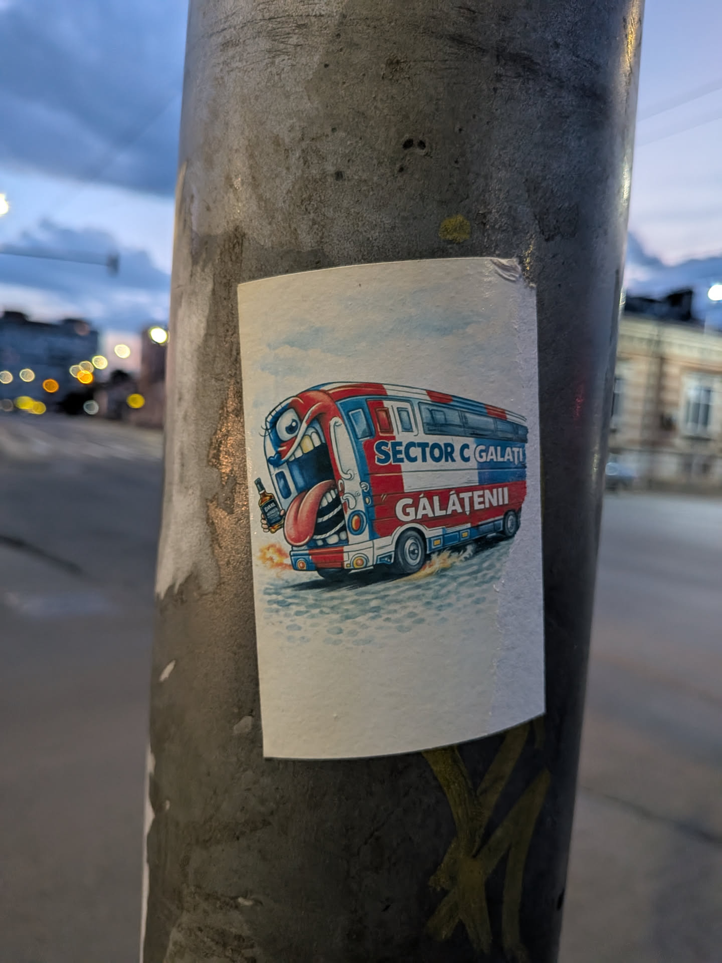 A rectangular sticker featuring a cartoon monster bus in red, white, and blue. The front of the bus is a monster face with a large open mouth, tongue sticking out, and a hand holding a bottle. The side reads 'SECTOR C GALAȚI' and 'GĂLĂȚENII'.