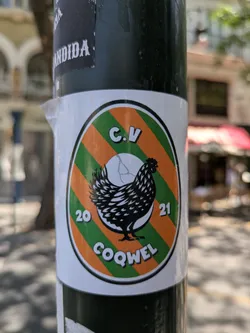 Street sticker This is a sticker featuring a black chicken silhouette. The background is a pattern of alternating orange and green stripes. Above the chicken are the letters 'C.V' and below, the word 'COQWEL'. The numbers '20' and '21' flank the sides of the chicken. The overall design is contained within a white circle with a black outline.