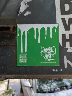Street sticker A square green sticker with a white dripping paint effect at the top. It features the AFCN logo on the bottom left and stylized 'Romanian Street Art' text with a website URL on the bottom right.