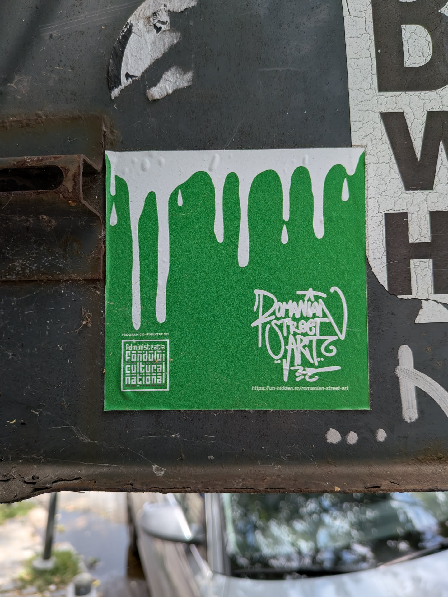 A square green sticker with a white dripping paint effect at the top. It features the AFCN logo on the bottom left and stylized 'Romanian Street Art' text with a website URL on the bottom right.
