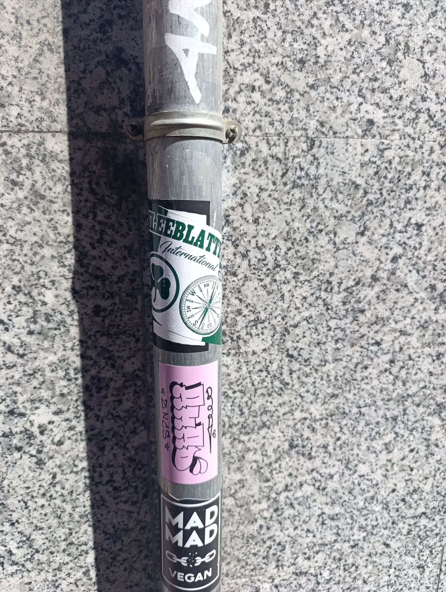 The sticker is a vertical pink rectangle featuring stylized white text with black outlines. On the left, small black text reads "*SPNZ*". The prominent central text, rendered in a graffiti bubble-letter style, appears to spell "Chills," with the initial 'C' resembling a cartoon hand or character and the final 's' also highly stylized. A small black abstract symbol is visible on the right side.