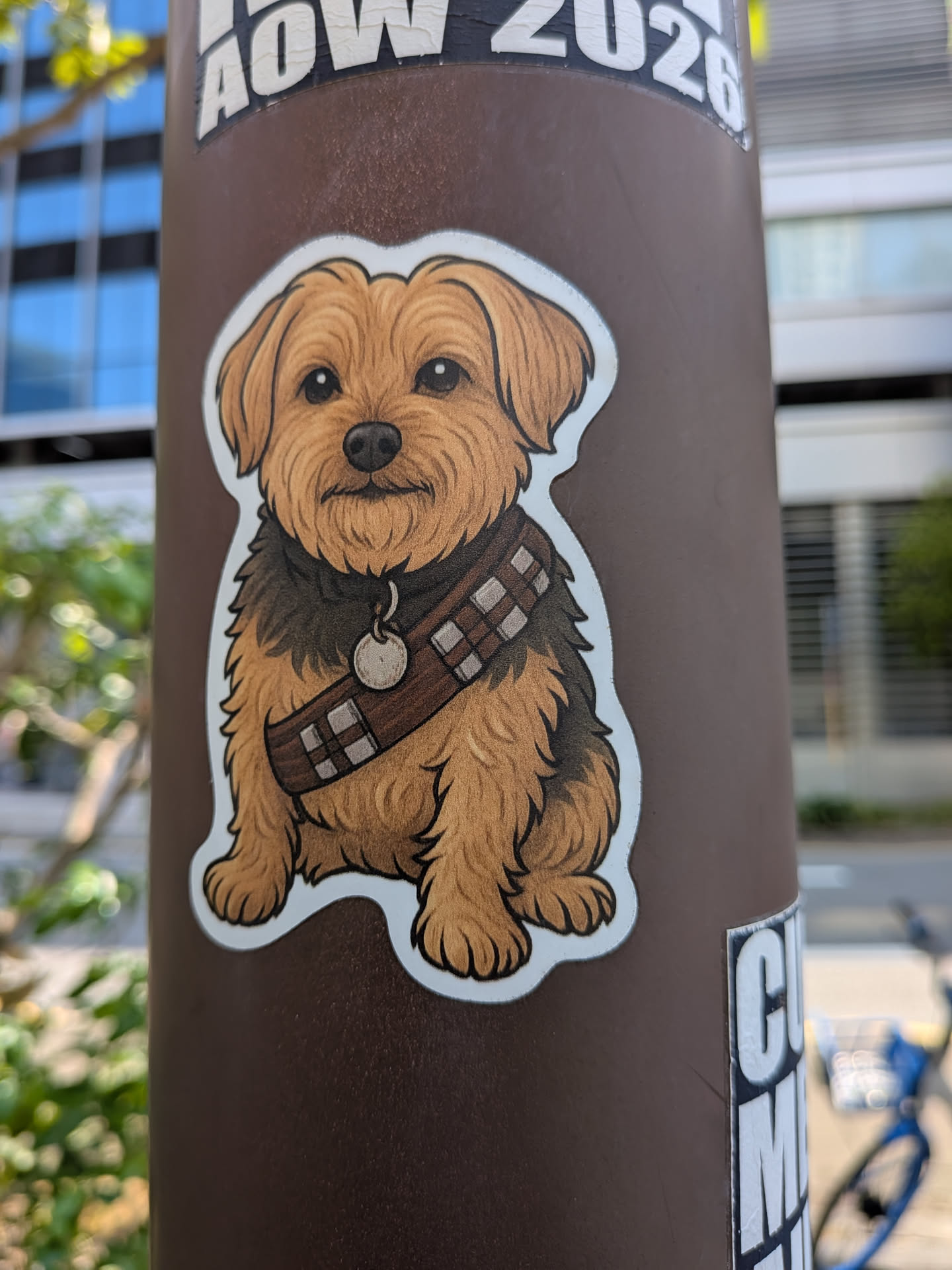 Die-cut sticker of a brown terrier dog wearing Chewbacca's bandolier. Features detailed fur texture and clean outlines.
