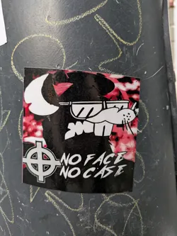 Street sticker The sticker features a stylized illustration of a white cartoonish character wearing sunglasses, set against a red and black background. The text "NO FACE NO CASE" is prominently displayed below the illustration, accompanied by a symbol resembling a circle with a cross inside.