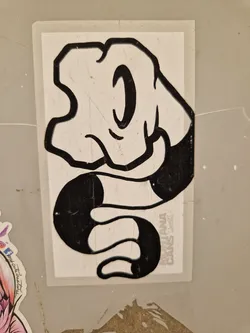 Black and white sticker featuring a cartoon hand morphing into a snake. The style is reminiscent of classic cartoons or graffiti art.  There's some text at the bottom, but it's partially obscured and difficult to read completely.