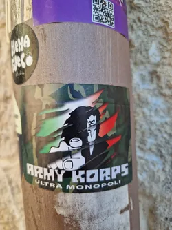 A sticker featuring a cartoon illustration of a man in a suit pointing at the viewer. The style is reminiscent of propaganda posters, with a camouflage background and a ripped effect. The text 'Army Korps Ultra Monopoli' is prominently displayed.