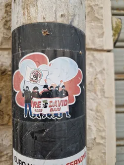 Street sticker A sticker featuring a cartoon illustration of a group of people, possibly Ultras, holding a banner that says "RE DAVID 1909 BARI". The illustration also shows a smoke or cloud-like effect. The style is reminiscent of a fan club or sports-related group.