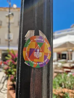 Street sticker Round sticker with a geometric design in bright colors. The center features a tree-like image with text that repeats around the edge: "BE UNIQUE BE UNIQUE BE UNIQUE BE UNIQUE..."