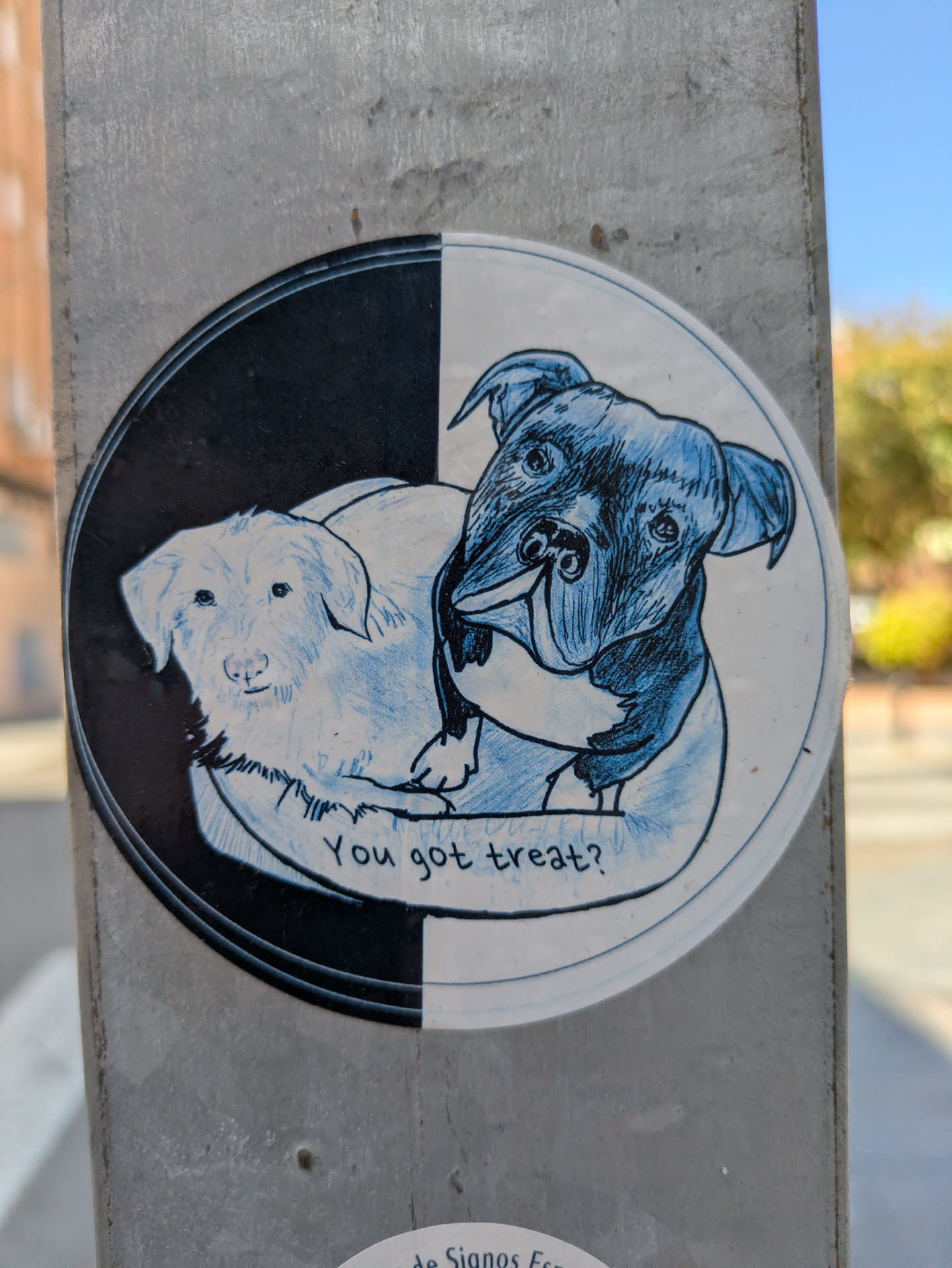 This sticker features a two-toned background with a drawing of two dogs. One dog, on the left, is white, and the other dog on the right is black. The dogs appear to be laying together. The text 'You got treat?' is written below them.