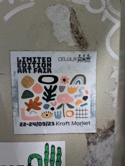 Street sticker A square white sticker featuring a collage of colorful abstract shapes, organic forms, and illustrations like an eye, a flower, and a rainbow. Text at the top reads 'LIMITED EDITION ART FAIR' and 'CELULA', while the bottom displays the dates '22-24/09/23 Kraft Market'.
