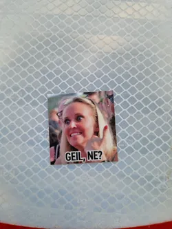 Street sticker A sticker featuring a woman giving a thumbs up with the text 'Geil, ne?' which translates to 'Cool, huh?' in German.  The sticker has a meme-like quality.