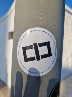 Street sticker A round, white sticker with a black, stylized logo resembling the letters "CC" or a similar abstract design. The phrase "Classic Club XXXI" is written in a circular pattern around the logo.