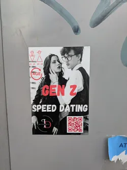 Street sticker A rectangular sticker adhered to a gray surface. It features a black and white image of a young couple, with the woman touching the man's face. Red text overlays the image, proclaiming "GEN Z SPEED DATING." A logo and a QR code are also present. The overall design has a modern and somewhat edgy aesthetic.