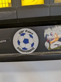 Street sticker This sticker features a soccer ball, surrounded by the words 'USV RAIKA' at the top and 'DOBERSBERG' at the bottom. It appears to be a promotional item or emblem for the soccer club USV Raika Dobersberg.