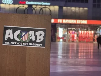 Street sticker A rectangular sticker with a black background and a thin white border. The prominent text 'ACAB' is displayed in large, distressed white letters. Centered between the 'C' and 'A' is the Atlético Madrid club crest, featuring a red and white striped shield with a blue canton containing seven white stars and a bear and strawberry tree, all encircled by a green laurel wreath. Below the main text, in smaller, white, slightly distressed font, it reads 'ALL CIERVOS ARE BASTARDS'. The overall aesthetic is gritty and defiant.