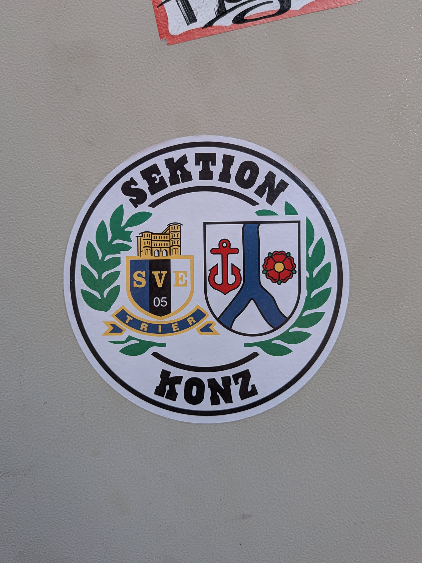Circular sticker featuring the SVE Trier 05 crest and the Konz coat of arms, enclosed by a green laurel wreath with 'SEKTION' and 'KONZ' text.