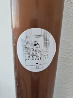 Round sticker featuring a drawing of a person looking out a window, surrounded by flowers. The sticker includes the text "CULTURA PANORAMICA" and contact information including email and social media links for Instagram and Facebook.