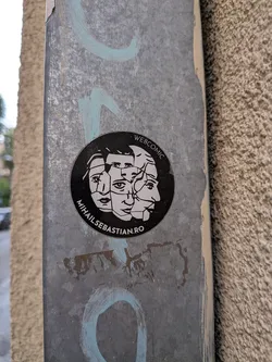 Street sticker A circular black sticker featuring a white graphic of shattered, overlapping faces. Text along the border reads 'WEBCOMIC' and 'MIHAILSEBASTIAN.RO'.