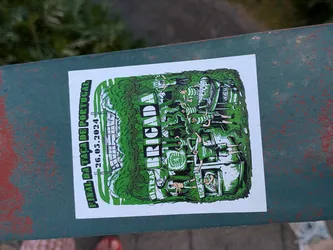Street sticker A rectangular sticker with a green and white illustration of Sporting CP supporters ('Brigada') partying in a forest. It depicts fans barbecuing and waving flags, with a stadium in the background. Text commemorates the Portuguese Cup Final on May 26, 2024.