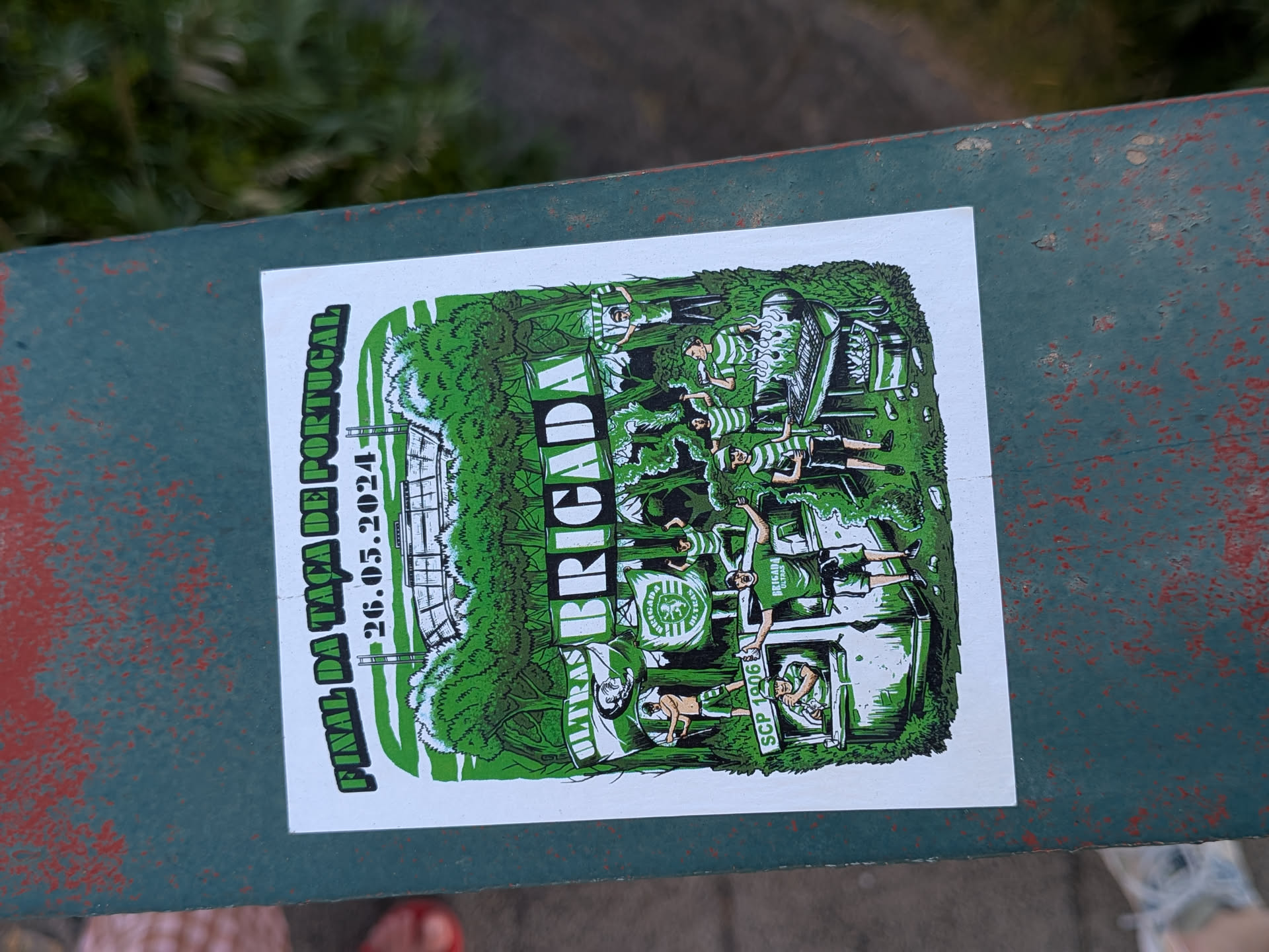 A rectangular sticker with a green and white illustration of Sporting CP supporters ('Brigada') partying in a forest. It depicts fans barbecuing and waving flags, with a stadium in the background. Text commemorates the Portuguese Cup Final on May 26, 2024.