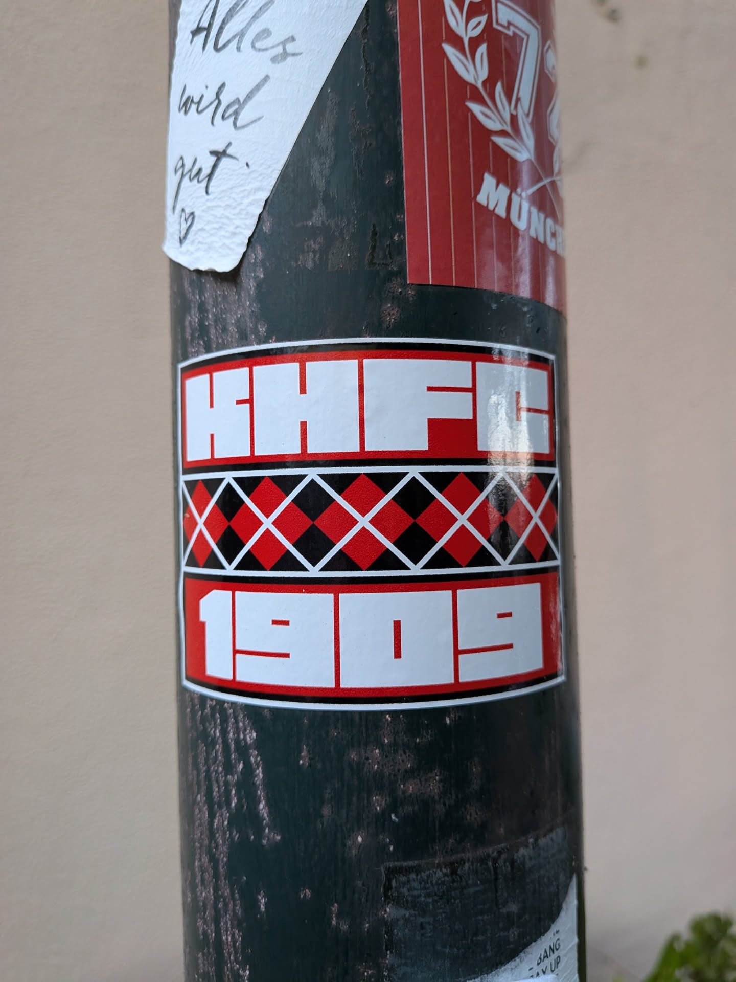 Rectangular sticker with three horizontal bands. Top and bottom bands feature bold white text 'HHFC' and '1909' on red backgrounds. The middle band displays a red and black argyle diamond pattern.