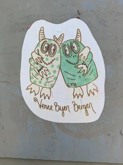 Street sticker The sticker depicts two cartoon-style, green monsters hugging. The monster on the left is a lighter green with darker green polka dots, while the monster on the right is a solid medium green. Both creatures have large, expressive eyes with concentric circles, stitched mouths resembling stitches, and small horns on their heads. They embrace each other with three-fingered hands. Below the monsters, the phrase "Venner Byen Bergen" is written in a brown, flowing script. Small initials "CFH" are also visible on the lower part of the right monster's body. The sticker itself is cut out in an irregular shape and placed on a weathered, light grey surface.