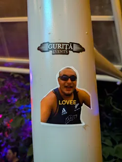 Street sticker A die-cut photo sticker of a bald man wearing dark sunglasses and a black Adidas All Blacks tank top. The word 'LOVEE' is written in yellow across his chest.