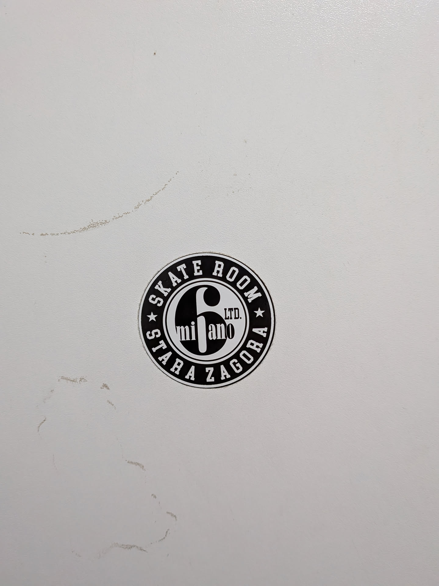 A round monochrome sticker. The outer border reads 'SKATE ROOM' and 'STARA ZAGORA' with star accents. The center features a large stylized '6', 'LTD.', and 'milano'.