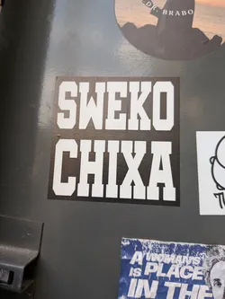 Street sticker A square black sticker featuring bold, white, collegiate-style block letters spelling 'SWEKO' on the top line and 'CHIXA' on the bottom.