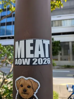 Street sticker A rectangular black sticker featuring bold white sans-serif text. The word 'MEAT' is prominently displayed on top, with 'AOW 2026' written underneath.
