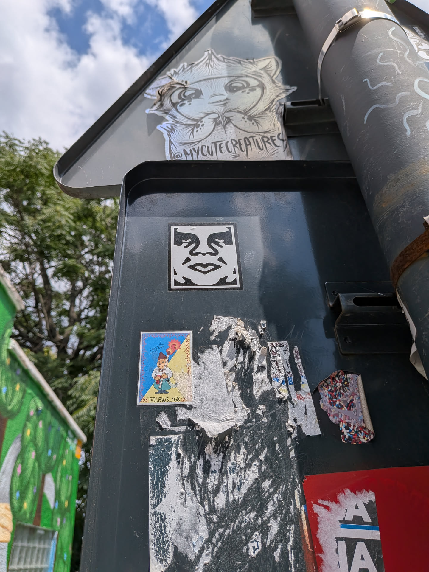 A square sticker featuring the high-contrast, black-and-white stylized face of Andre the Giant, created by artist Shepard Fairey.