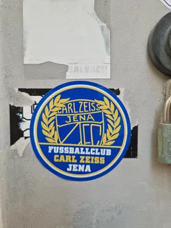 A round blue and gold sticker featuring the logo of Fussballclub Carl Zeiss Jena. The logo includes the team's name, a crest, and a laurel wreath.