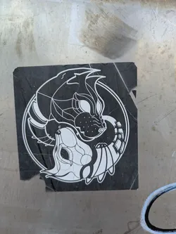 Street sticker This sticker depicts a black and white design in the style of a yin-yang symbol. On one side, there's a wolf with sharp features and intricate details. On the other side, there's a lamb with similar design elements. Both are contained within a circular border on a black background.