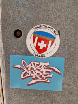 A light blue square sticker with red graffiti art that says Art Core. 