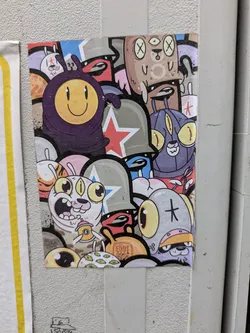 A sticker shows a compilation of colorful cartoon characters. It has multiple eyes, stars, smileys and other abstract shapes, creating a unique and eye-catching design.