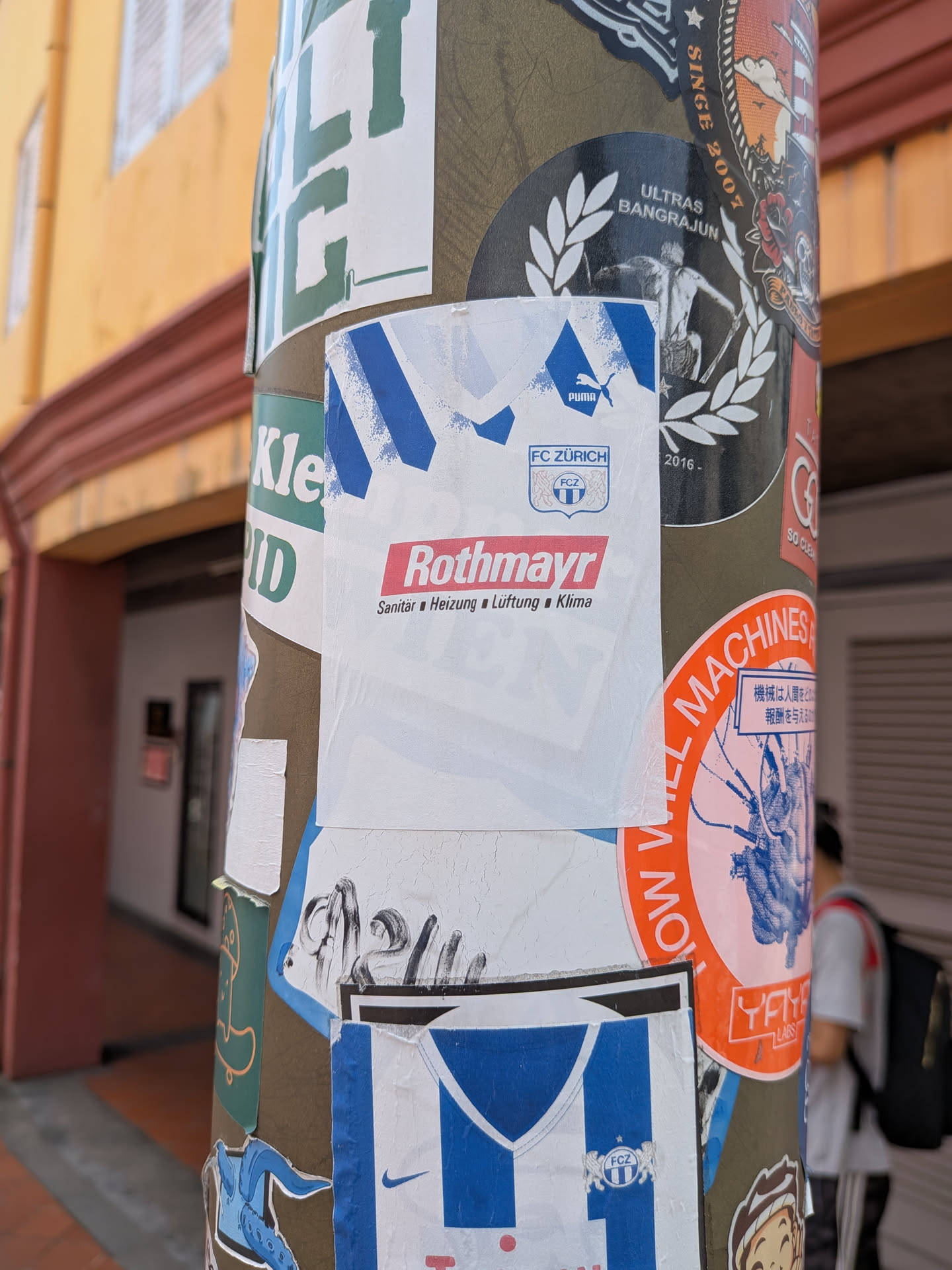 A white, jersey-shaped sticker featuring blue shoulder details, the Puma logo, the FC Zürich crest, and the red 'Rothmayr' sponsor logo with German text underneath.