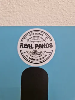 Street sticker Round sticker with black and white design. It features a globe, text that says "Real Pakos", and other text around the globe that says "Odio Eterno", "2004", and "Al Borja Moderno".