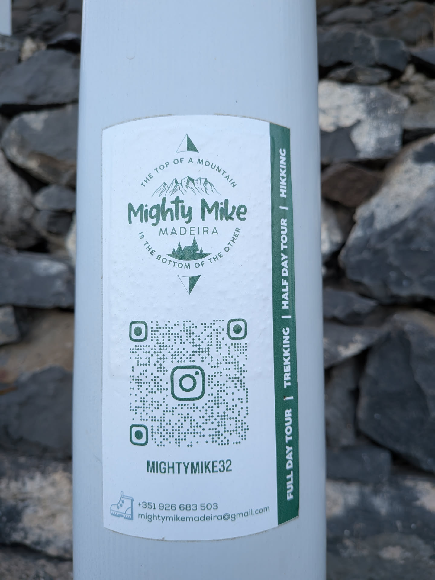 A white rectangular sticker with green print. It features a mountain-themed logo at the top, a central QR code with an Instagram icon, contact details at the bottom, and a green vertical stripe on the right listing tour options.