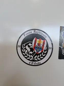 Street sticker This round sticker features the logo of the C.D. Onda soccer team, based in Onda, Spain. The text 'Frente Rojiblanco' and 'C.D. Onda' frame the logo. The logo has the team's shield, which is adorned with a crown and the image of a castle, and has a soccer ball in the bottom portion of the shield. The year 2024 is also printed on the right and 2020 on the left.